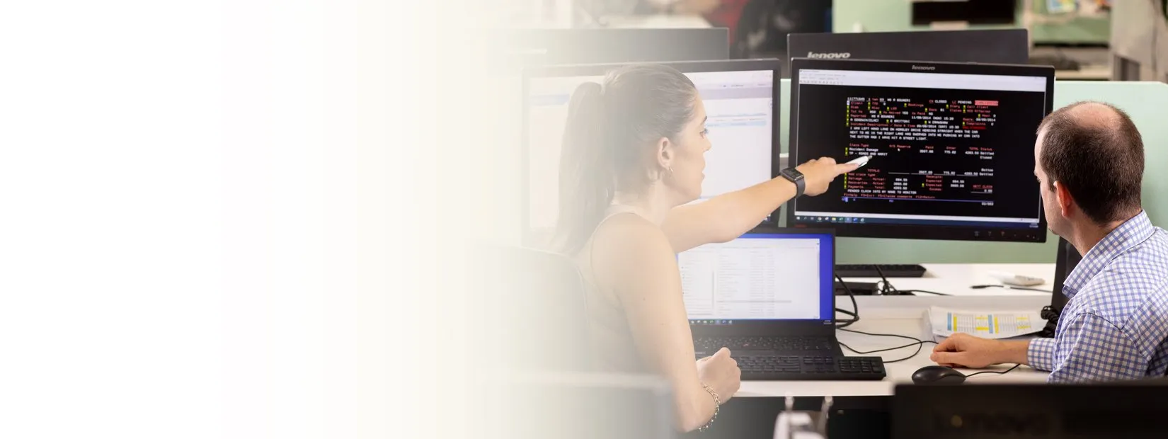 Colleague pointing at monitor