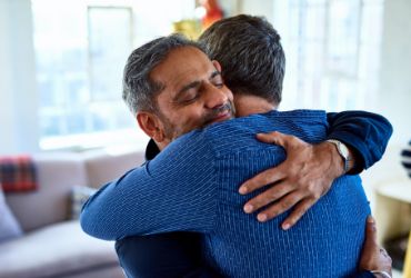 Two men hugging