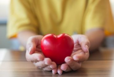 Someone holding a heart shaped ornament
