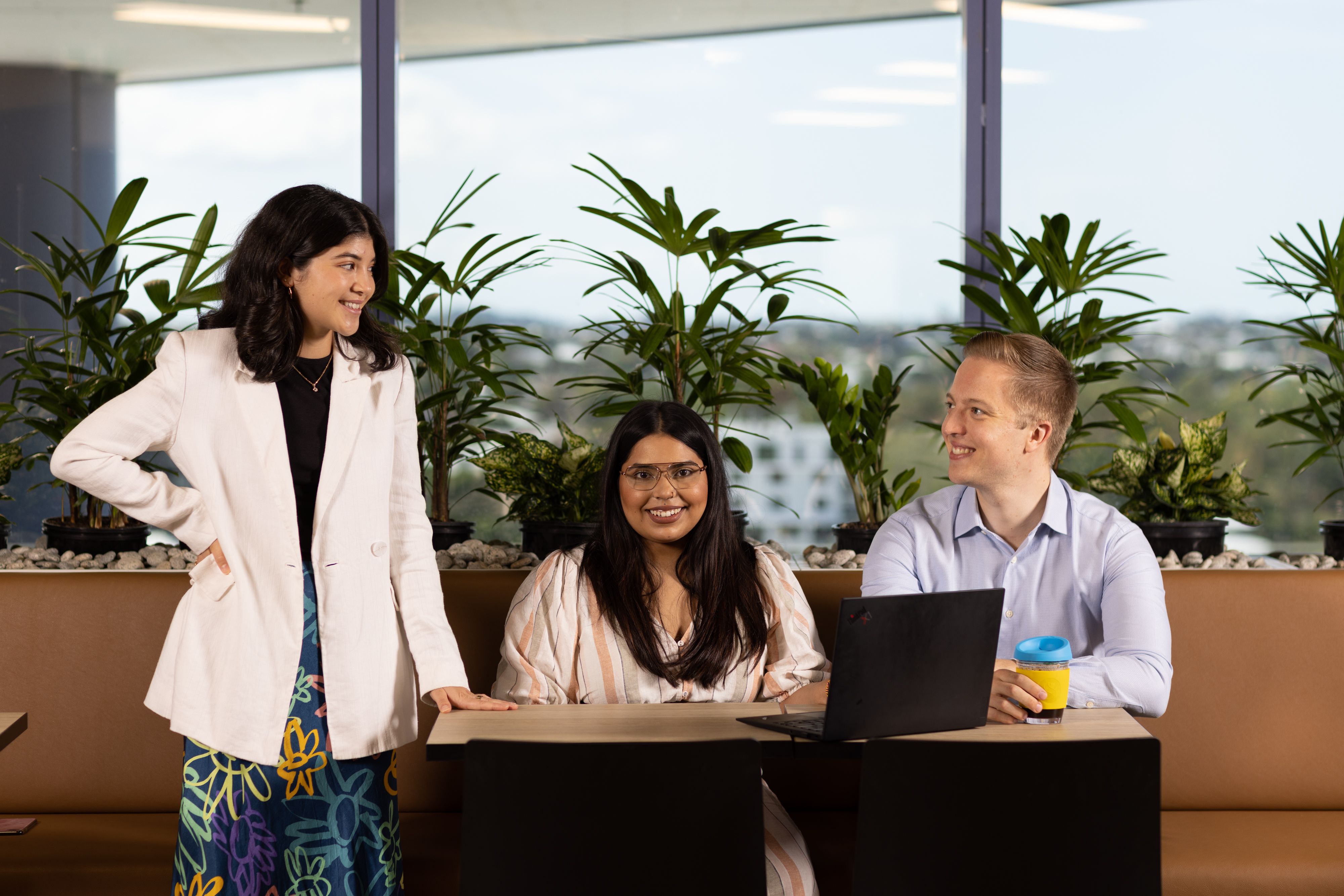 three people at a workstation